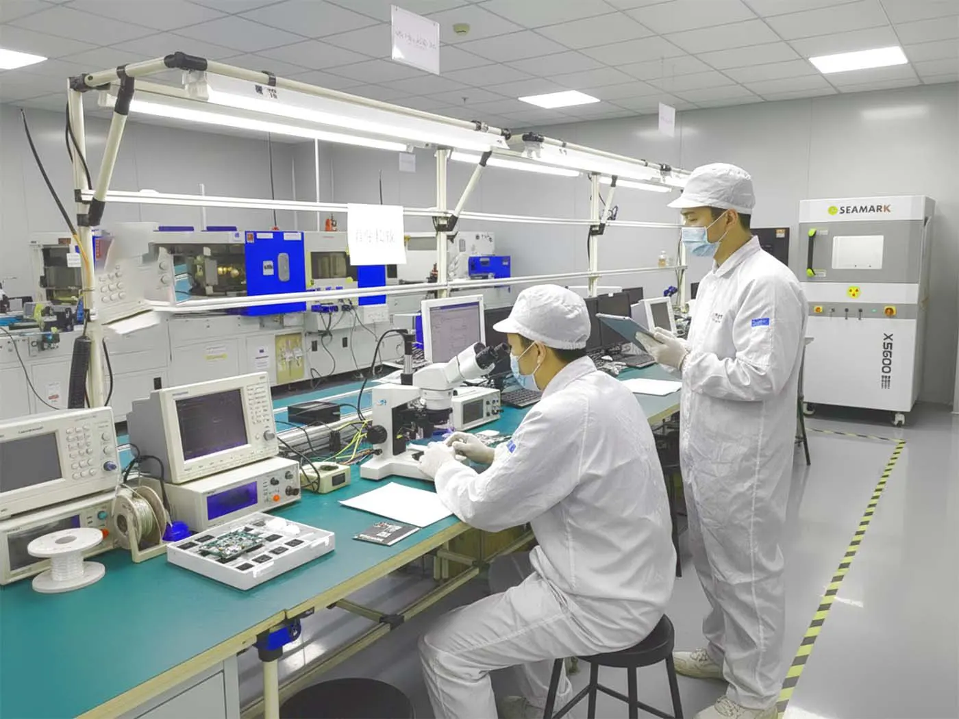 Defining a Top PCBA Company Engineer reviewing a PCB design on a computer